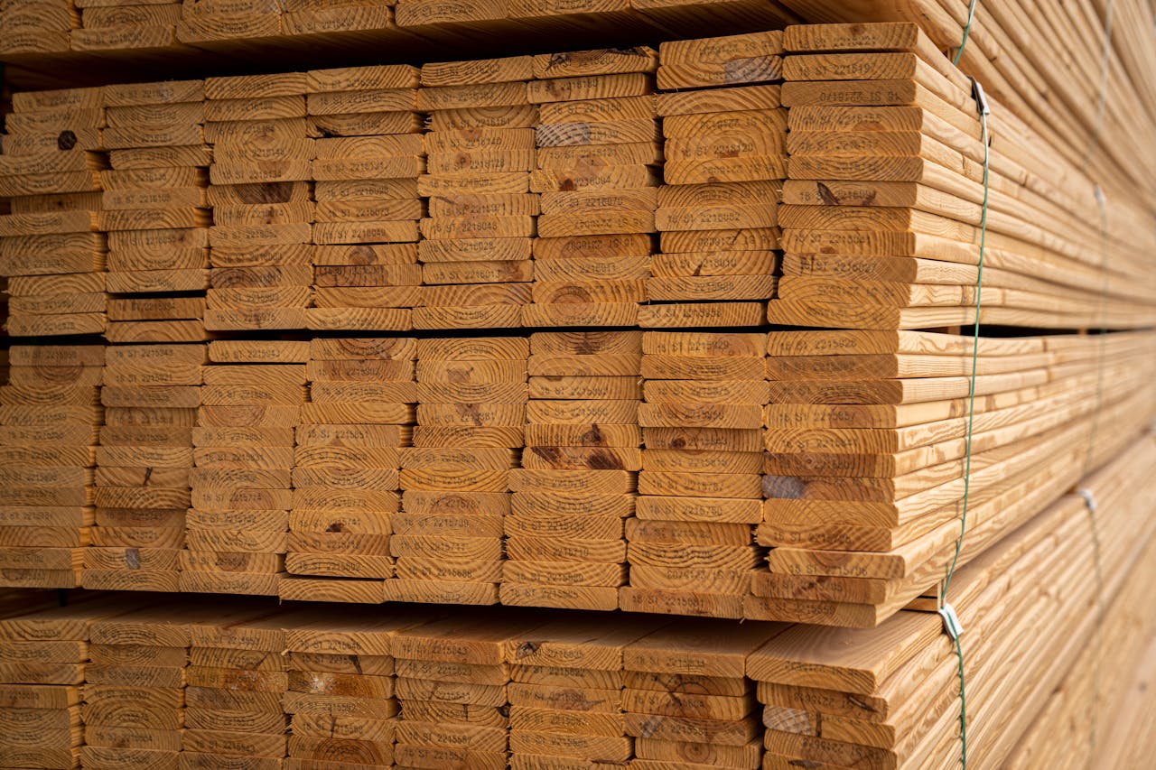 Close-up of stacked wooden planks, perfect for construction, showcasing natural wood textures.